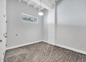 Thumbnail 44 of 51 - a bedroom with gray carpeting and a white exposed beam on the ceiling