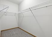 Thumbnail 45 of 66 - Empty room with a grey carpet and a white wall.