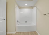Thumbnail 8 of 56 - a white bathroom with a shower and a tub