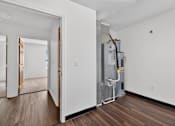 Thumbnail 45 of 49 - A room with a wood floor and a wall-mounted air conditioning unit.