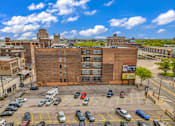 Thumbnail 42 of 51 - a large brick building with a parking lot in front of it