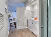 Thumbnail 48 of 50 - a small kitchen with white appliances and a dining room in the background