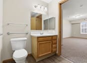 Thumbnail 48 of 66 - A white toilet sits next to a sink in a small bathroom.