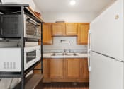 Thumbnail 37 of 37 - a kitchen with wooden cabinets and a white refrigerator