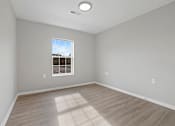 Thumbnail 17 of 78 - an empty room with wood floors and a window
