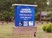Thumbnail 32 of 50 - a sign in front of a house that says harbor meadows 144 sherman dr