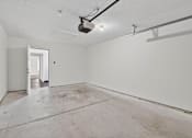 Thumbnail 38 of 49 - A large empty room with a concrete floor and white walls.