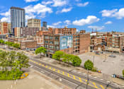 Thumbnail 45 of 51 - an aerial view of a city street with buildings in the background and a blue sky in the
