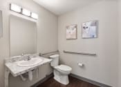 Thumbnail 33 of 37 - a bathroom with a sink and a toilet and a mirror