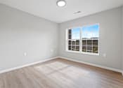 Thumbnail 15 of 78 - an empty room with wood floors and a window