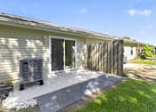 Thumbnail 41 of 49 - A house with a grey door and a grey bench in front of it.
