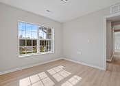 Thumbnail 13 of 78 - an empty living room with a large window
