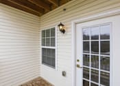Thumbnail 53 of 66 - A white door with a window and a light on the wall.