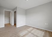 Thumbnail 12 of 78 - the living room and dining room of a house with white walls and wood floors