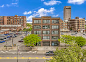 Thumbnail 8 of 51 - a brick building with a garage in the middle of a city