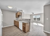 Thumbnail 2 of 18 - A kitchen with a white refrigerator and wooden cabinets.