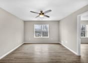 Thumbnail 8 of 51 - an empty living room with a ceiling fan and a window