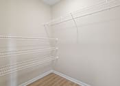 Thumbnail 14 of 76 - the closet in the bedroom of a home with white walls and