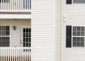 Thumbnail 55 of 66 - A white house with a balcony and a door.