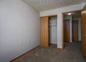 Thumbnail 21 of 33 - A room with a white wall and a brown door.