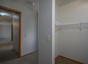Thumbnail 26 of 33 - A white wall with a light switch and a white shelf.