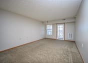 Thumbnail 5 of 33 - A room with a carpeted floor and two windows.