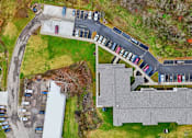 Thumbnail 60 of 66 - A parking lot with cars parked in it.