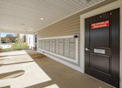 Thumbnail 31 of 84 - the front door of a building with mailboxes and a sign that reads post office
