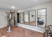 Thumbnail 27 of 45 - a row of mirrors on the wall in a gym with wood flooring