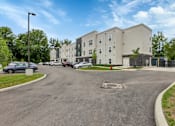Thumbnail 40 of 45 - a large apartment building with cars parked in front of it