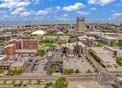Thumbnail 10 of 51 - an aerial view of a city with a large white building in the middle
