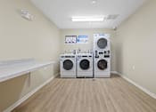 Thumbnail 38 of 78 - a washer and dryer in a laundry room with a counter
