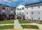 Thumbnail 9 of 22 - an apartment building with a sidewalk in front of it