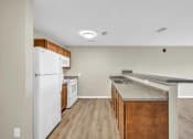 Thumbnail 5 of 51 - a kitchen with an island and a white refrigerator