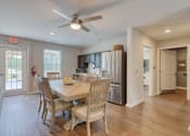 Thumbnail 17 of 50 - a dining room and kitchen area with a table and chairs and a ceiling fan