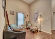 Thumbnail 17 of 25 - a living room with a leather couch and two chairs