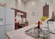Thumbnail 16 of 25 - a kitchen with a refrigerator freezer and a stove top oven