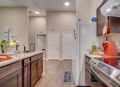 Thumbnail 15 of 25 - a kitchen with wooden cabinets and stainless steel appliances