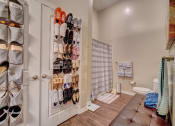 Thumbnail 14 of 25 - a closet filled with shoes next to a toilet