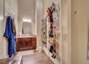 Thumbnail 13 of 25 - a walk in closet in a bedroom with a sink and a mirror
