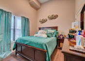 Thumbnail 12 of 25 - a bedroom with a bed and a window