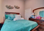 Thumbnail 11 of 25 - a bedroom with a bed and a dresser