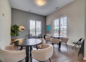 Thumbnail 23 of 25 - a room with tables and chairs and two large windows