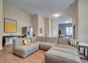 Thumbnail 21 of 25 - a large couch in a living room with a kitchen in the background