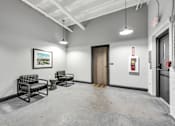 Thumbnail 18 of 51 - a waiting area with two chairs and a toilet