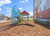 Thumbnail 3 of 35 - a playground with a slide at an apartment complex