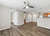 Thumbnail 16 of 53 - A room with a ceiling fan and wooden flooring.