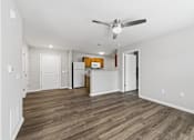 Thumbnail 21 of 53 - A room with a ceiling fan and wooden flooring.