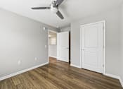 Thumbnail 22 of 53 - A room with a ceiling fan and two doors.