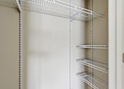 Thumbnail 20 of 53 - Empty shelves in a white pantry.